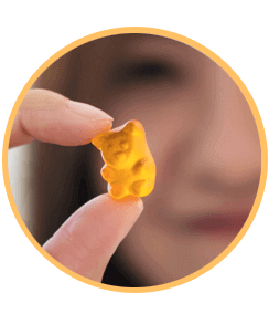 A Pure Vive gummy held between two fingers